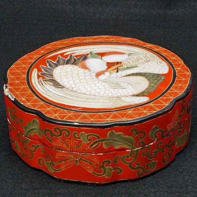 A handmade and painted lacquer box with an interesting scalloped shape and an auspicious design of crane and peach. The...