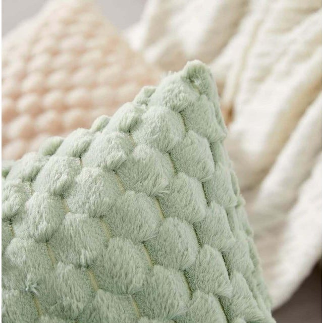This is a decorative throw pillow featuring a unique soft textured design in a soothing green color. The pillow measures...