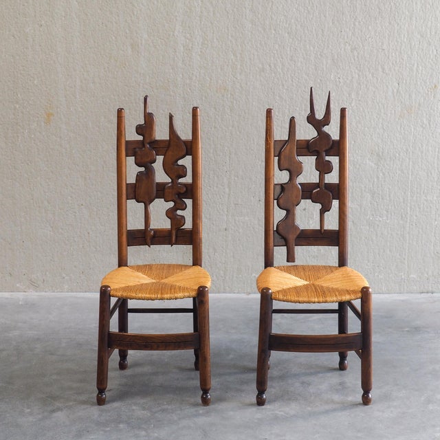 An extraordinary pair of mid-century high-back chairs that bridge the line between functional furniture and fine art....