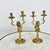 A Dutch pair of 19th century brass candelabra featuring heraldic lions of the Amsterdam coat of arms who clutch the...