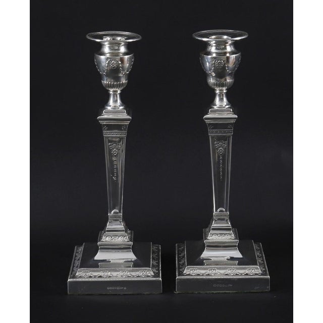 This is an exquisite pair of antique English Victorian Neo Classical silver-plated candlesticks bearing the maker's mark...