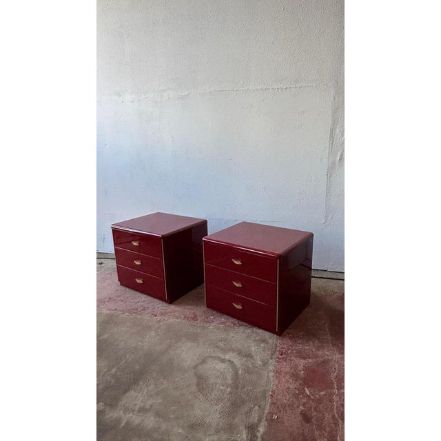 A pair of gloss lacquer side cabinets perfect bedside cabinets. These pieces feature triple drawers with amazing gold tone...