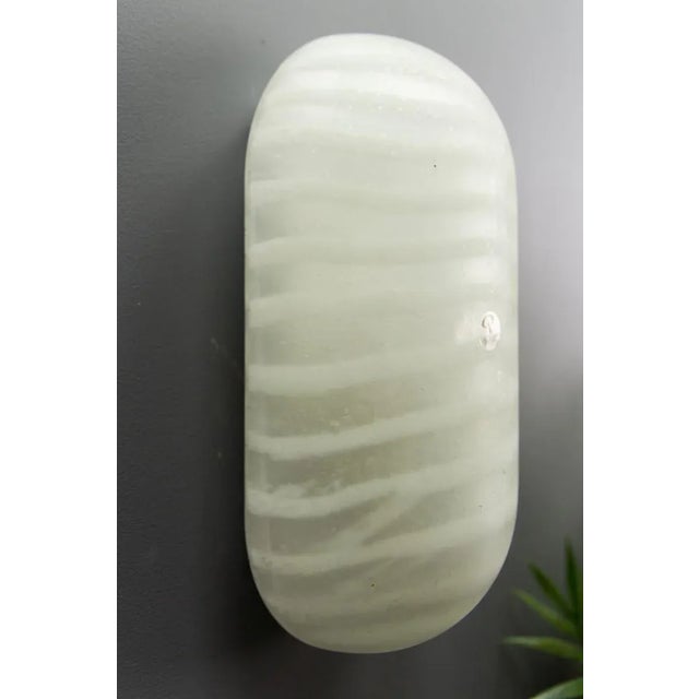 - This sconce is made of thick hand blown frosted glass features design with darker and brighter stripes; - manufactured...
