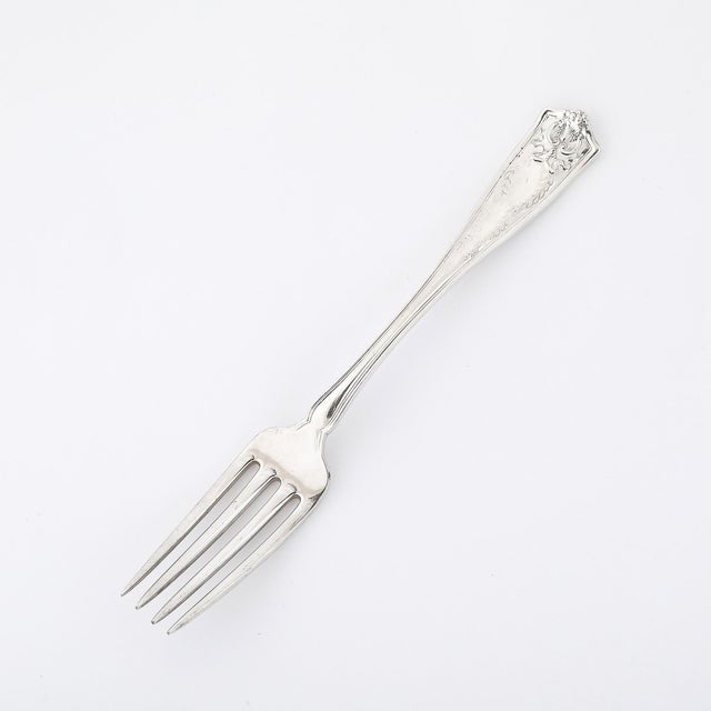 This elegant sterling silver dinner fork by Tiffany & Co. showcases the renowned Winthrop Pattern, a design synonymous...