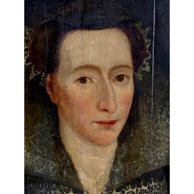 A late 16th Century British portrait of a woman in oil on oak panel. The painting depicts an upper class woman in her...