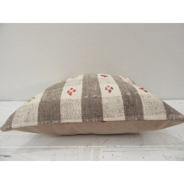 This is a pillow cover made from a vintage kilim rug. The piece was properly washed and ready to use. Pillow inserts not...
