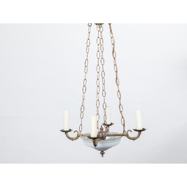 A French opaline chandelier from the early 20th century, with four lights and profiled links. Created in France at the...