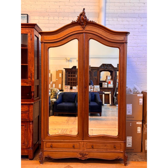 Design Plus Gallery presents an Antique Louis XV Style Mirrored Armoire. Constructed from wood, this tall cabinet has a...