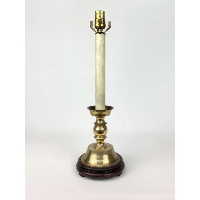 Beautiful candlestick table lamp with graceful lines.Bright Brass color and finished with gilt details.