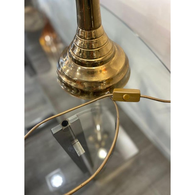 This elegant brass table lamp features a refined faux bamboo stem that evokes vintage designs from the '70s. The white...