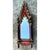 This mirror presents a dramatic, architecturally inspired silhouette drawn directly from Gothic ecclesiastical design, its...