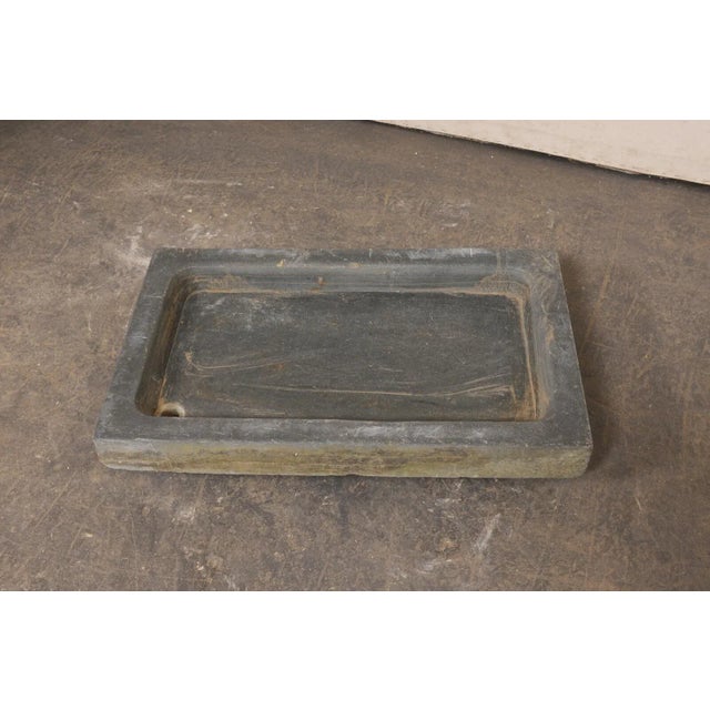 A Portuguese carved-stone sink, with shallow basin and off-set drain hole, from the turn of the early 20th century. This...