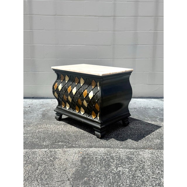 A refined Hollywood Regency accent chest by Vanleigh featuring a crisp marble top, sculptural black lacquered case, and...