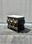 A refined Hollywood Regency accent chest by Vanleigh featuring a crisp marble top, sculptural black lacquered case, and...