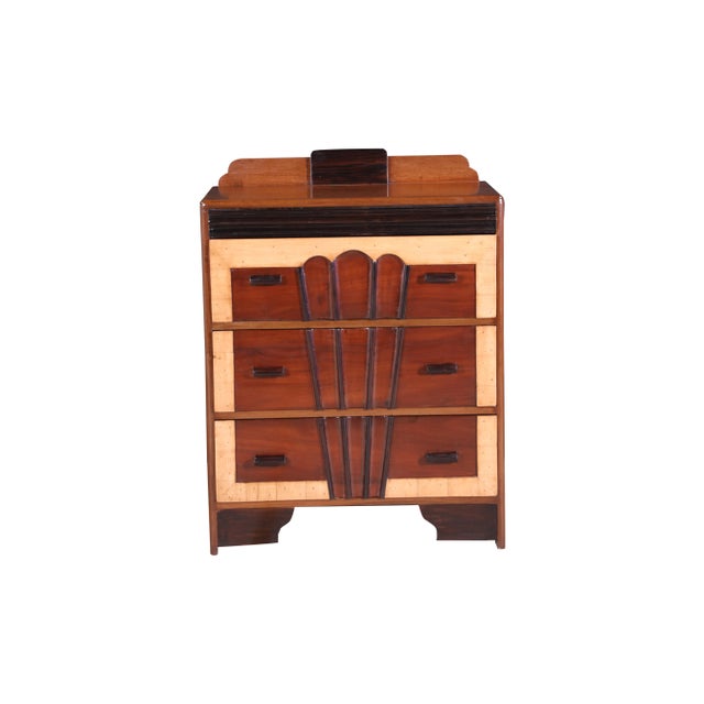 A late Art Deco Chest of Drawers or Dresser. The body is predominantly teak wood with a satinwood border and additional...
