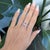 A romantic toi et moi ring featuring a 1.1ct padparadscha sapphire (oval 6×4mm) paired in a sparkling diamond halo, set in...