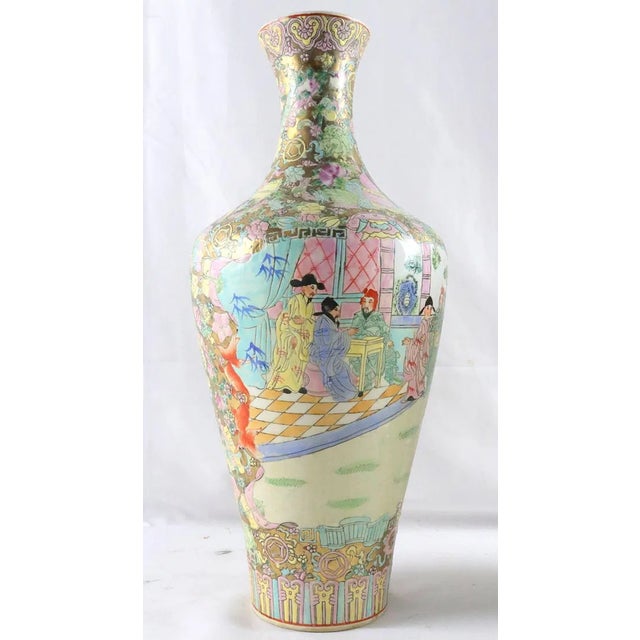 A decorative pair of Chinese Famille Rose porcelain vases, each finely painted with polychrome enamels in the traditional...