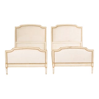 Louis XVI Style Painted Twin Beds With Nail Head Upholstered Headboard and Foot Board Circa 1940 - A Pair For Sale