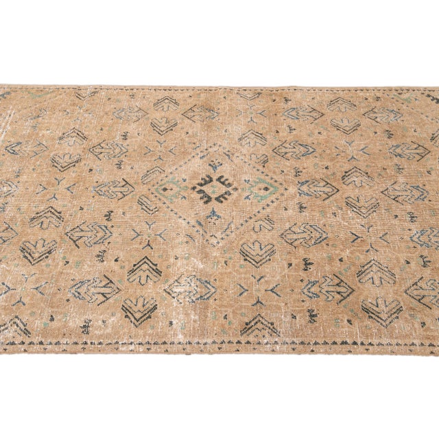 Beautiful Vintage Persian Distressed Hand-knotted Wool Rug with the beige field. This piece has blue accents in an all-...