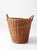 Vintage wicker gathering basket with a tall tapered form, twisted loop handles, and a tightly woven body. The warm honey...