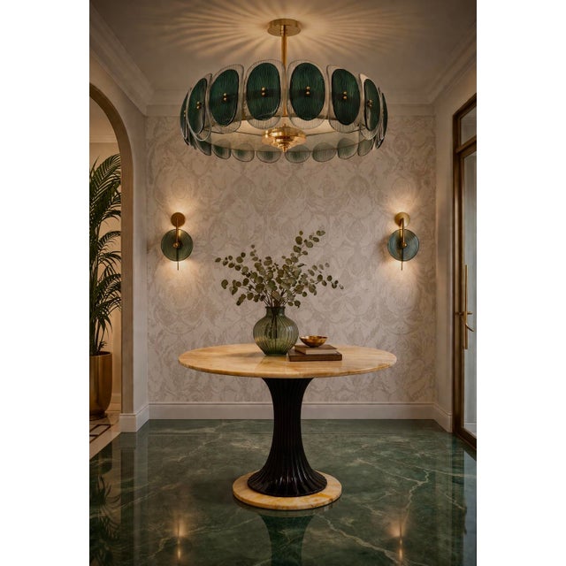 Round Murano chandelier with a brass frame and distinctive amber and cream-colored glass. The refinement and class,...