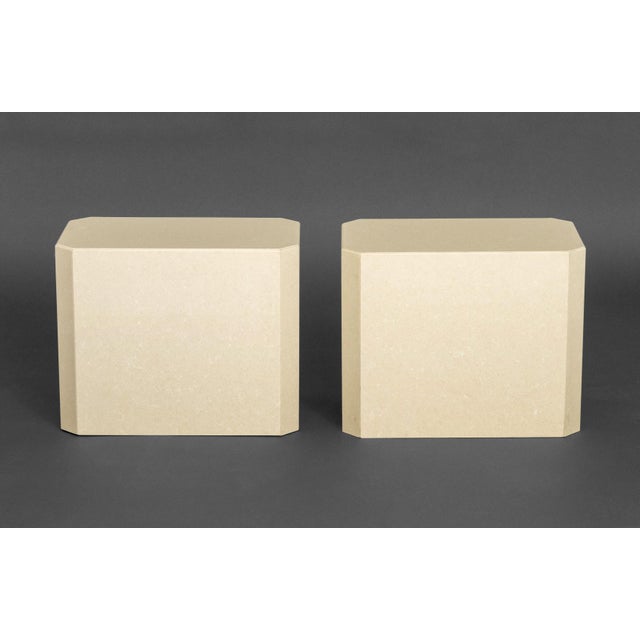 Pair of Modern Beige Stone Pedestal Tables, rectangular with canted corners. 16.25" H x 20" W x 12" D. Provenance: From a...