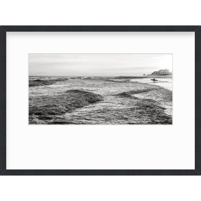 This fine art photograph by Paula McIntosh was taken in Charleston, South Carolina. A surfer watches the waves before...
