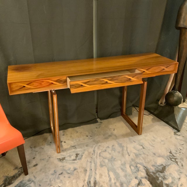 Helix console table in Santos Rosewood and walnut. Double helix motif, and marquetry inlay. There’s a center drawer....