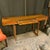 Helix console table in Santos Rosewood and walnut. Double helix motif, and marquetry inlay. There’s a center drawer....