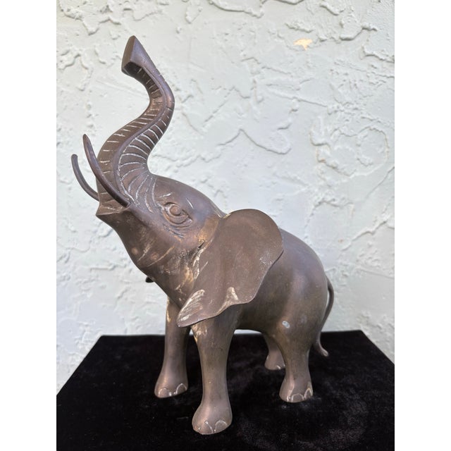 Bring a touch of global charm to your décor with this vintage hand-cast brass elephant sculpture, featuring a beautifully...