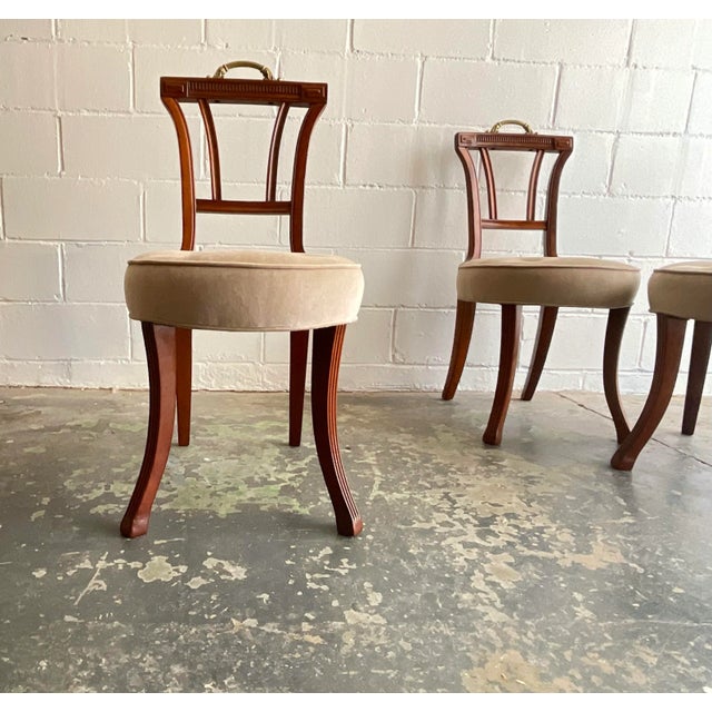 Petite yet comfortable set of four dining or side chairs in wonderfully patinated mahogany with original brass handles....