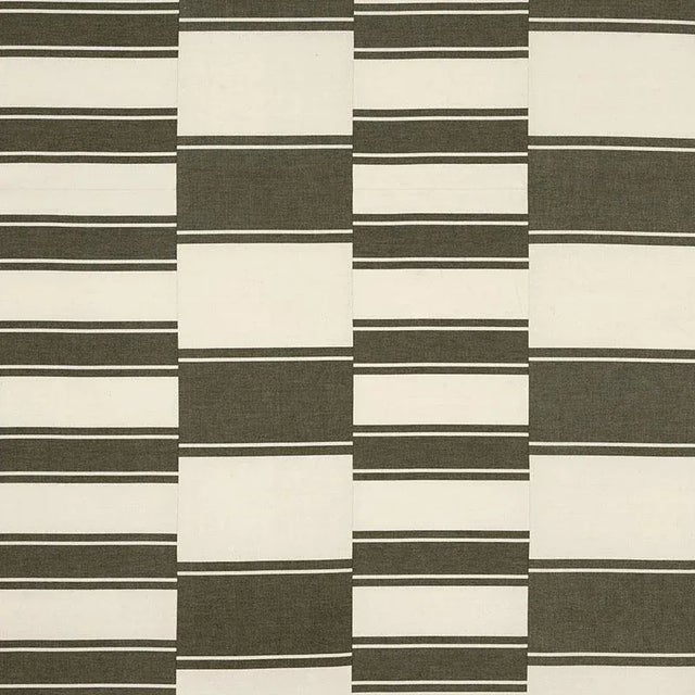 Woven lengths of medium- and large-scale stripes are cut into strips, then pieced together for handmade, statement-making...