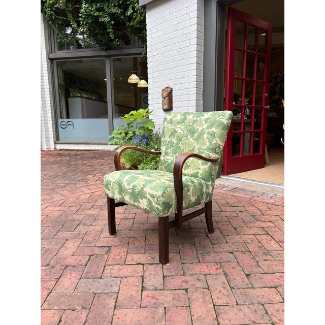 Elegant Danish Modern lounge chair crafted in Denmark, circa 1950s, featuring a solid oak frame with softly rounded,...