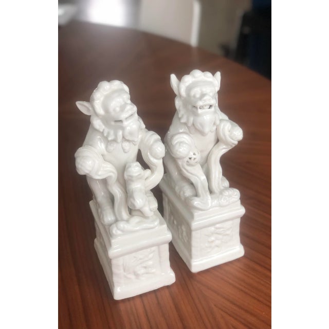 This is an absolutely gorgeous pair of male and female foo dogs. The porcelain is glazed in a rich, creamy ivory and both...