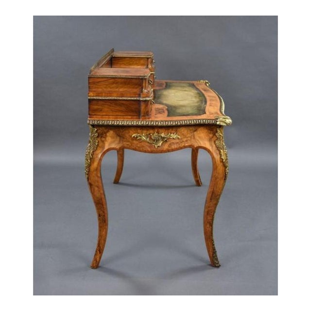 A highly decorative Victorian burr walnut writing table, beautifully finished with rich figured veneers and ornate gilt...