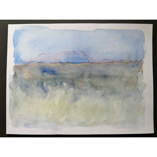 This watercolor piece captures a serene landscape transitioning from the rolling plains of Nebraska towards the distant...