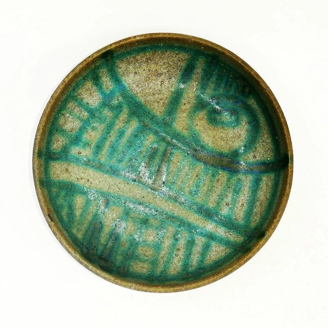 This bowl is painted with geometric decoration and signed Fognani Faenza.