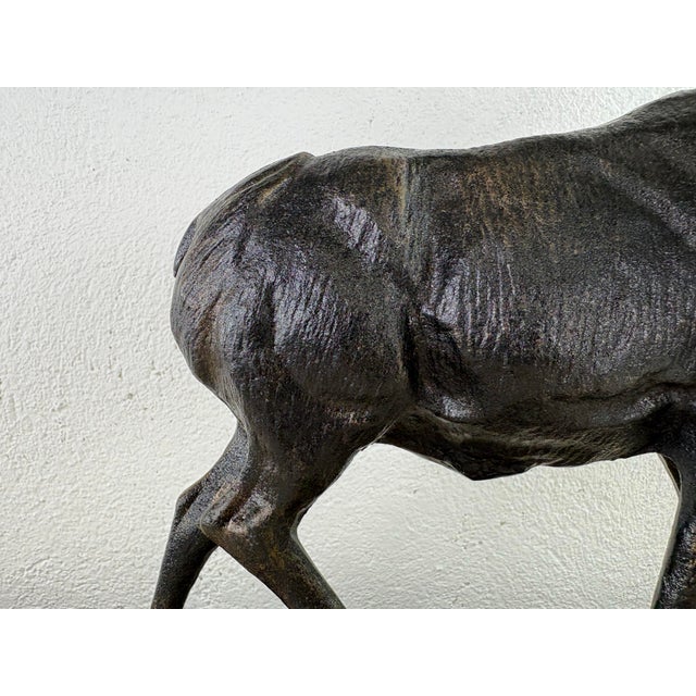 This is a large vintage sculpture of a stag. This cast-iron sculpture has a patinated bronze to the surface with a natural...
