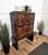 Beautiful 1940s Italian Art Deco bar cabinet in great wood veneer, three front doors, standing on waterfall legs giving...