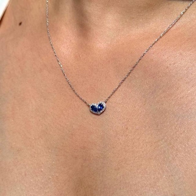 This heart pendant necklace features 0.61 carats of natural blue sapphires set in 14K white gold. Each sapphire measuring...