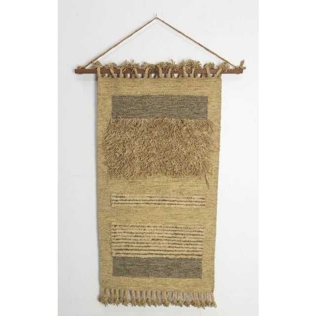 Wood and wool wall tapestry. Wall rug made circa 1970. The weaver of this rug has used wool in different ways to bring out...