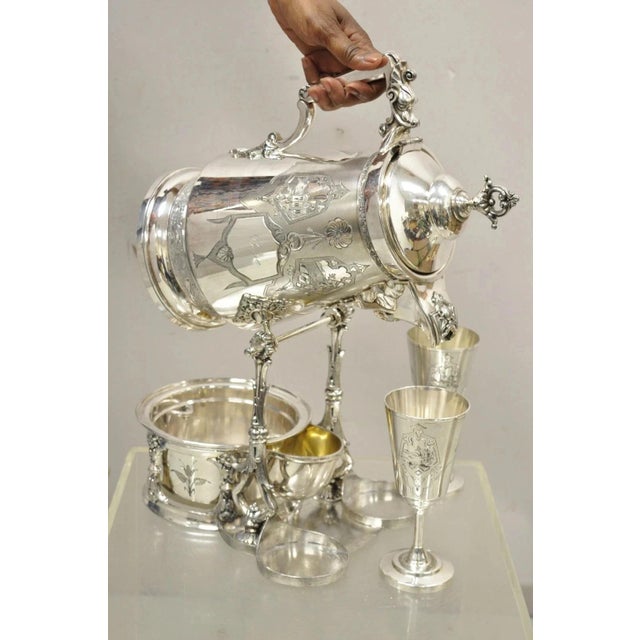 Antique Victorian Silver Plated Tilting Lemonade Water Pitcher on Stand w Goblets by Racine. Item features stunning ornate...