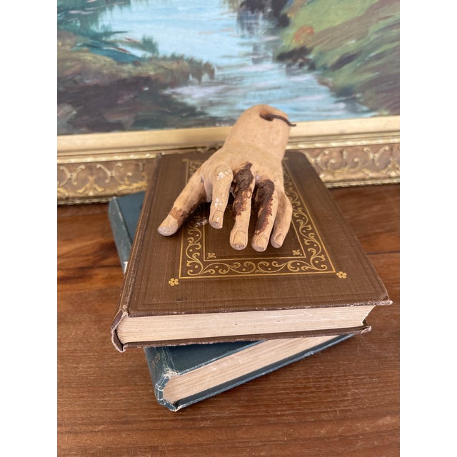 This antique carved wooden hand fragment dates to the 19th century and was likely part of a larger religious figure or...