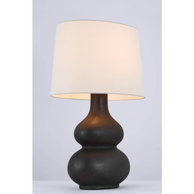 Lismore Medium Table Lamp in Stained Black Metallic with Linen Shade Designer: Chapman & Myers Height: 23.75" Shade...
