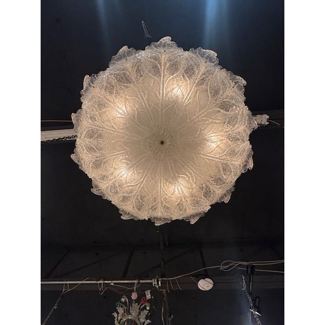 Beautiful clear "Granola" glass Murano flush mount chandelier. Featuring glistening glass in the shape of leaves. Makes an...