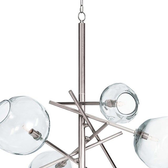 This chandelier’s hand-crafted glass shades combined with polished nickel lend a distinct, artisan effect. Molten glass...