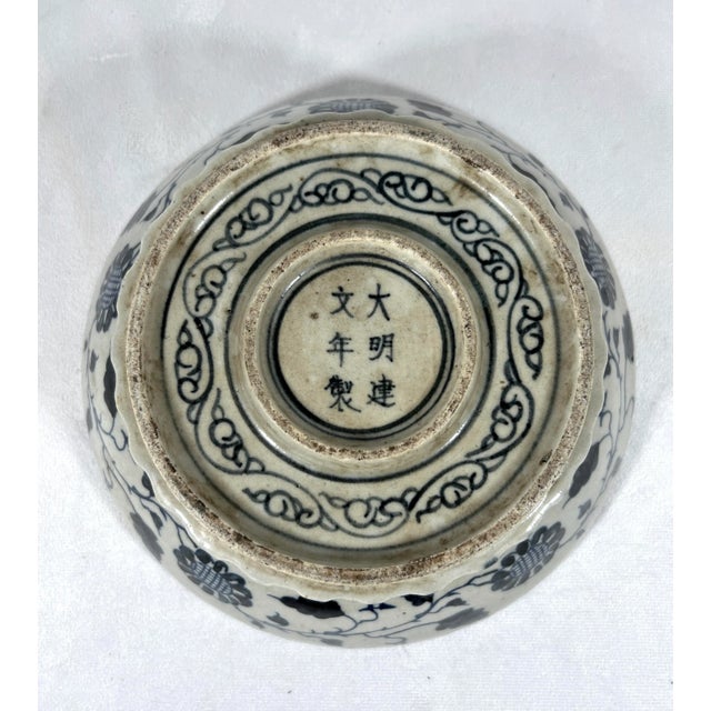 A very unusual round Chinese bowl that is hand decorated throughout with flowers, carp fish and scroll work in dark blue...