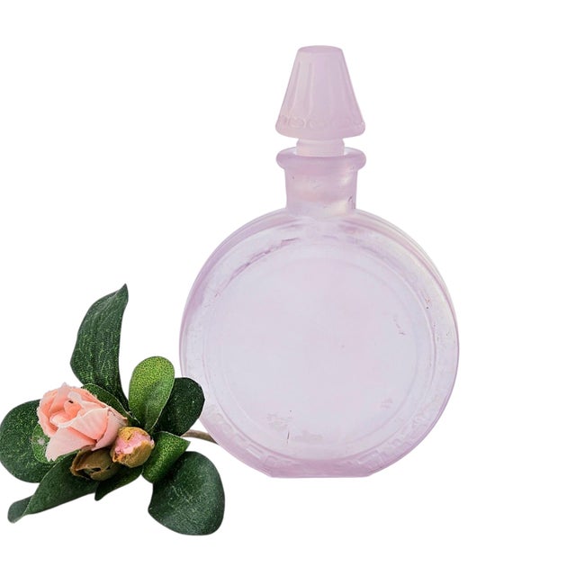 An early 20th-century American frosted glass perfume bottle, produced during the Depression era and exhibiting manganese-...