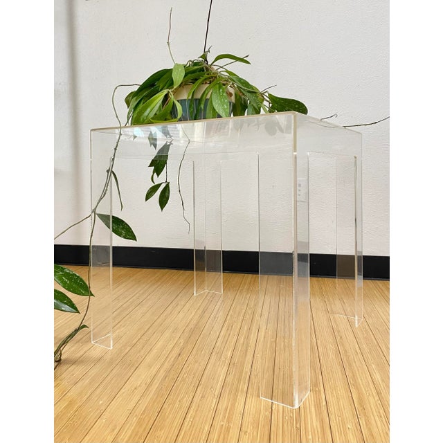 Great looking 1970s era side table/plant stand in clear acrylic (Lucite). We love the legs and stance on this vintage...