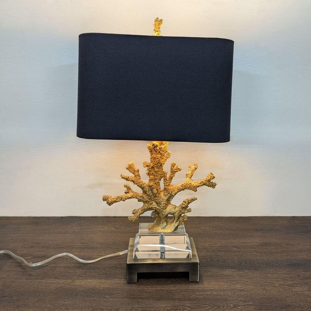 This unique table lamp features a striking gold faux coral-shaped base with realistic texture and detail. The lamp has a...